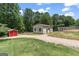Property with a large outbuilding, a storage shed, and a fenced enclosure at 135 Brookshire Dr, Fayetteville, GA 30215