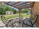 Outdoor patio area with seating and a pergola at 135 Brookshire Dr, Fayetteville, GA 30215