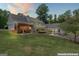 Expansive home featuring a spacious lawn, outdoor seating area, and screened-in porch at 135 Brookshire Dr, Fayetteville, GA 30215