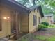 A shot of the house's exterior showing a simple entrance and the home's yellow paint and brown trim at 106 Garden Trl, Stockbridge, GA 30281