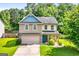 Charming two-story home featuring a well-manicured lawn and a mix of brick and siding accents at 149 Pristine Dr, Locust Grove, GA 30248