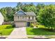 Charming two-story home featuring a well-manicured lawn and a welcoming entrance at 149 Pristine Dr, Locust Grove, GA 30248