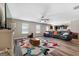 Open-concept living room with fireplace, wood floors, and view to the kitchen at 149 Pristine Dr, Locust Grove, GA 30248