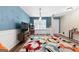 Living room featuring modern decor, wood floors and an accent wall at 149 Pristine Dr, Locust Grove, GA 30248