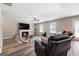 Spacious living room features a fireplace, ceiling fan and wood-look flooring at 149 Pristine Dr, Locust Grove, GA 30248