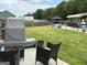 Cozy patio set, view of backyard with pool, seating area, and covered grill space at 175 Bridgemill Dr, Covington, GA 30014
