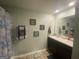 Bright bathroom featuring a double vanity with great lighting, decorative mirrors, and a shower/tub combo at 175 Bridgemill Dr, Covington, GA 30014