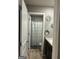 Bright bathroom features a shower with geometric curtain, granite countertop, and decorative mirrors at 175 Bridgemill Dr, Covington, GA 30014