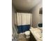 Neutral-toned bathroom featuring a shower with a stylish blue and white curtain at 175 Bridgemill Dr, Covington, GA 30014