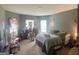 Relaxing bedroom featuring ample natural light, cozy carpet, and stylish decor, creating a tranquil and inviting retreat at 175 Bridgemill Dr, Covington, GA 30014