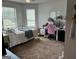 Bright bedroom with carpet, complemented by a window and stylish decor for a comfortable and inviting atmosphere at 175 Bridgemill Dr, Covington, GA 30014