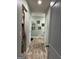 Bright hallway with wood floors, artwork, and multiple doorways creates an inviting path at 175 Bridgemill Dr, Covington, GA 30014