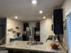 Open kitchen boasts granite countertops, stainless steel appliances, and dark cabinets, great for entertaining at 175 Bridgemill Dr, Covington, GA 30014
