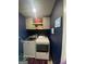Convenient laundry room with modern washer and dryer, storage cabinets, and stylish dark blue walls at 175 Bridgemill Dr, Covington, GA 30014