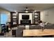 Modern living room features a fireplace, built-in shelves, a large sectional, and wood-look floors at 175 Bridgemill Dr, Covington, GA 30014