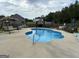 Backyard pool area with a clean pool surrounded by concrete and various seating options at 175 Bridgemill Dr, Covington, GA 30014