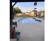 Backyard pool with a concrete surround, featuring a wind chime, lounge chairs, and wooden fence at 175 Bridgemill Dr, Covington, GA 30014