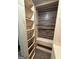Bright walk-in closet featuring custom wood shelving and wood-look wall covering, offering ample storage and organization at 175 Bridgemill Dr, Covington, GA 30014