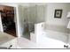 Elegant bathroom showcasing a glass shower, separate tub, double sink, and walk-in closet entrance at 2845 Long Shadow Ct, Snellville, GA 30078
