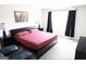 Bright bedroom with natural light, a dark bed frame, and matching black nightstands at 2845 Long Shadow Ct, Snellville, GA 30078