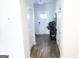 Bright hallway featuring hardwood floors and leading to a white front door with glass panels at 2845 Long Shadow Ct, Snellville, GA 30078
