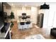 Open-concept kitchen with white cabinets, stainless steel appliances, and an island with barstool seating at 2845 Long Shadow Ct, Snellville, GA 30078