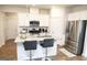 Modern kitchen features granite countertops, stainless steel appliances, and a convenient island with barstool seating at 2845 Long Shadow Ct, Snellville, GA 30078