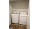 Practical laundry area with a white washing machine and dryer, plus convenient shelving at 2845 Long Shadow Ct, Snellville, GA 30078