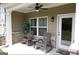 Relaxing covered porch with rocking chairs, ceiling fan, and brick accents at 2845 Long Shadow Ct, Snellville, GA 30078