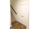 Carpeted staircase with wood handrail, and access to closet with wooden floors at 2845 Long Shadow Ct, Snellville, GA 30078