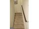Carpeted staircase with wood handrail, providing access to the home's upper levels at 2845 Long Shadow Ct, Snellville, GA 30078