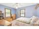 Cozy bedroom with natural light, a ceiling fan, and blue walls at 9706 Holly Hill Way, Jonesboro, GA 30238