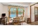 Cozy breakfast nook featuring natural light with a view of the backyard pool at 9706 Holly Hill Way, Jonesboro, GA 30238