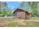 Exterior angle of the house with backyard pool and grassy lawn at 9706 Holly Hill Way, Jonesboro, GA 30238
