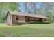 Ranch-style home with brick exterior, mature landscaping, and a large lawn, providing a serene and inviting curb appeal at 9706 Holly Hill Way, Jonesboro, GA 30238