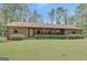 Charming one-story brick home with manicured lawn and lush surrounding greenery at 9706 Holly Hill Way, Jonesboro, GA 30238