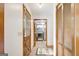 Hallway featuring wood flooring, laundry room access, and closet space at 9706 Holly Hill Way, Jonesboro, GA 30238