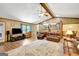 Open living room featuring hardwood floors, ceiling fan, and comfortable leather furniture at 9706 Holly Hill Way, Jonesboro, GA 30238