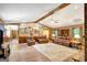 Expansive living room with hardwood floors, ceiling fan and a built-in bar at 9706 Holly Hill Way, Jonesboro, GA 30238