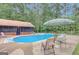 Backyard pool featuring an inground pool and a lounge area with shade at 9706 Holly Hill Way, Jonesboro, GA 30238