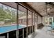 Spacious screened porch with a view of the pool and outdoor living area at 9706 Holly Hill Way, Jonesboro, GA 30238