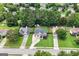 Aerial view of the home showcasing its manicured lawn, double garage, and the surrounding neighborhood at 341 Jodeco Station E Cir, Stockbridge, GA 30281