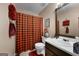 The bathroom features a single sink, toilet, and a shower with a plaid curtain at 341 Jodeco Station E Cir, Stockbridge, GA 30281