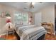 This cozy bedroom features wood floors, a ceiling fan, and a window with blinds at 341 Jodeco Station E Cir, Stockbridge, GA 30281
