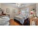 This cozy bedroom features wood floors, a ceiling fan, and a window with blinds at 341 Jodeco Station E Cir, Stockbridge, GA 30281