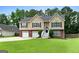 Inviting home featuring a well-kept lawn, tidy landscaping, and a welcoming front entrance at 341 Jodeco Station E Cir, Stockbridge, GA 30281