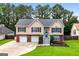 Charming home featuring a brick and siding exterior, well-manicured lawn, and an inviting front entrance at 341 Jodeco Station E Cir, Stockbridge, GA 30281