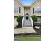 Inviting front entrance with landscaped flower beds, a black front door, and decorative plants at 341 Jodeco Station E Cir, Stockbridge, GA 30281