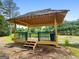 Wooden gazebo overlooking a pond, offering a serene space for relaxation and enjoying nature at 341 Jodeco Station E Cir, Stockbridge, GA 30281