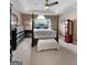 Bright primary bedroom featuring a tray ceiling, ceiling fan and a four poster bed at 341 Jodeco Station E Cir, Stockbridge, GA 30281